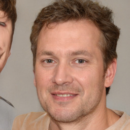 Joyful white adult male with short  brown hair and brown eyes