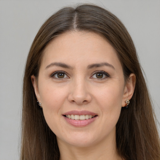 Joyful white young-adult female with long  brown hair and brown eyes