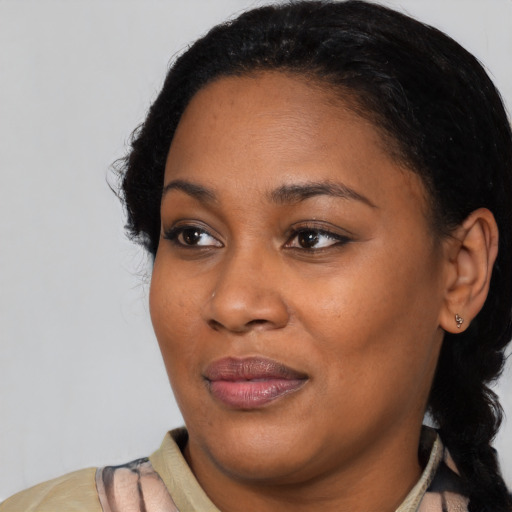 Joyful black young-adult female with medium  black hair and brown eyes