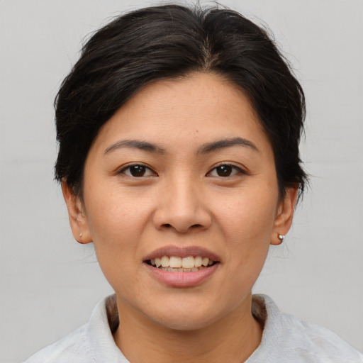 Joyful asian young-adult female with medium  brown hair and brown eyes