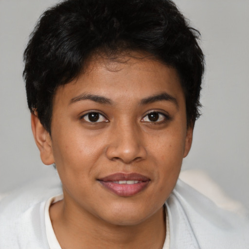 Joyful latino young-adult female with short  black hair and brown eyes