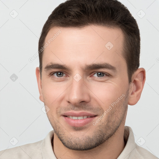 Joyful white young-adult male with short  brown hair and brown eyes