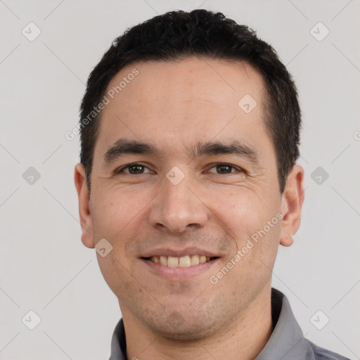 Joyful white adult male with short  black hair and brown eyes