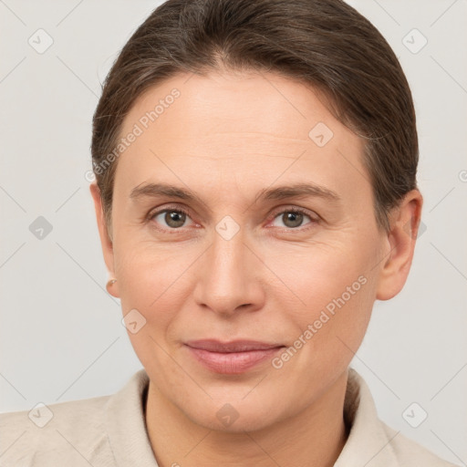 Joyful white adult female with short  brown hair and brown eyes