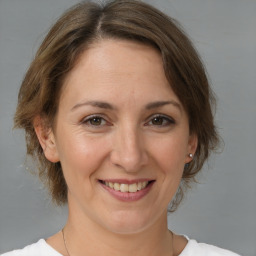 Joyful white adult female with medium  brown hair and brown eyes