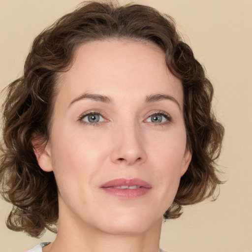 Joyful white young-adult female with medium  brown hair and green eyes