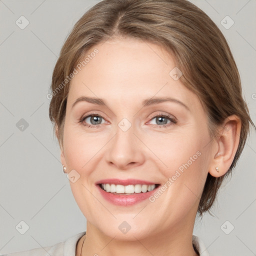 Joyful white young-adult female with medium  brown hair and grey eyes