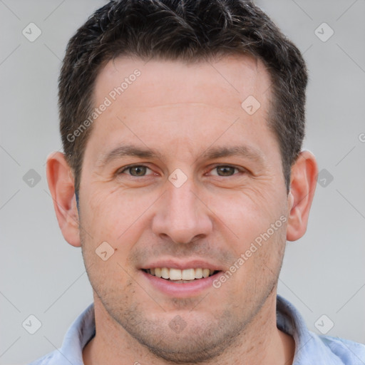 Joyful white adult male with short  brown hair and brown eyes