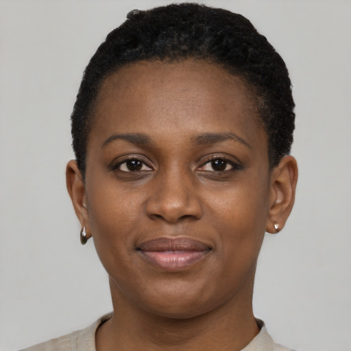 Joyful black young-adult female with short  black hair and brown eyes