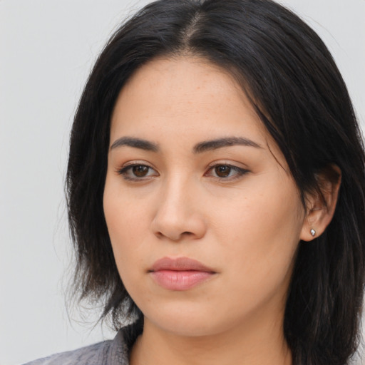 Neutral latino young-adult female with long  black hair and brown eyes