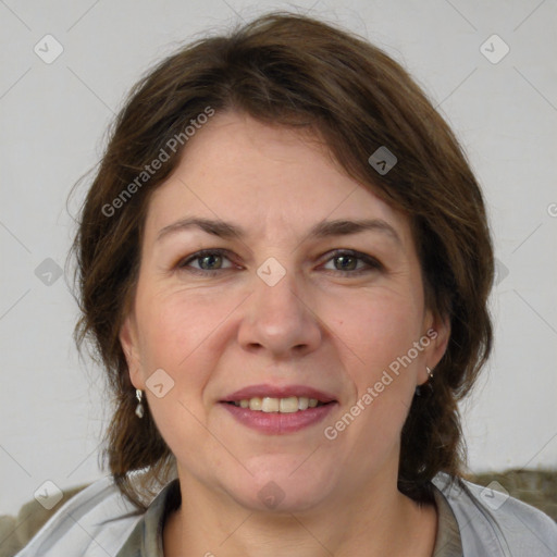 Joyful white adult female with medium  brown hair and grey eyes