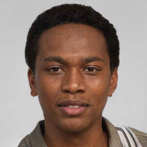 Joyful black young-adult male with short  black hair and brown eyes