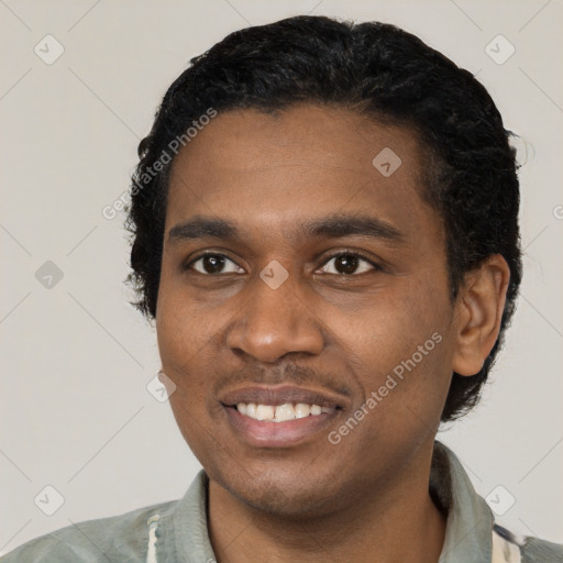 Joyful black young-adult male with short  black hair and brown eyes