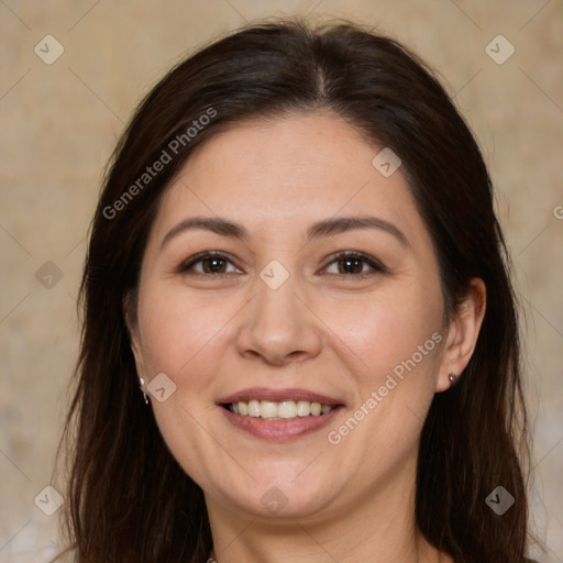 Joyful white adult female with long  brown hair and brown eyes