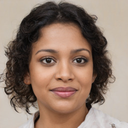 Joyful latino young-adult female with medium  brown hair and brown eyes