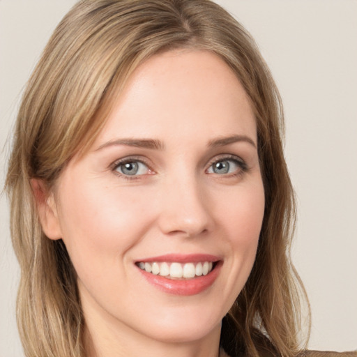 Joyful white young-adult female with long  brown hair and grey eyes