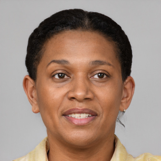 Joyful latino adult female with short  brown hair and brown eyes