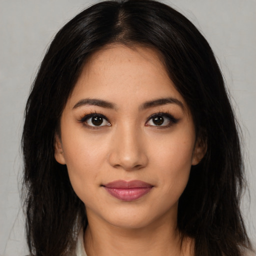 Joyful latino young-adult female with long  black hair and brown eyes