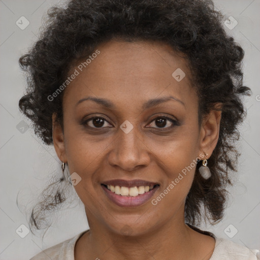 Joyful black adult female with medium  brown hair and brown eyes