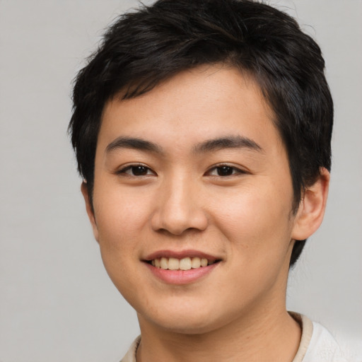 Joyful asian young-adult male with short  brown hair and brown eyes