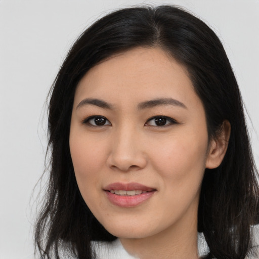 Joyful asian young-adult female with long  brown hair and brown eyes