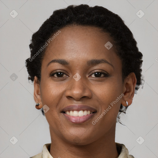 Joyful black young-adult female with short  brown hair and brown eyes