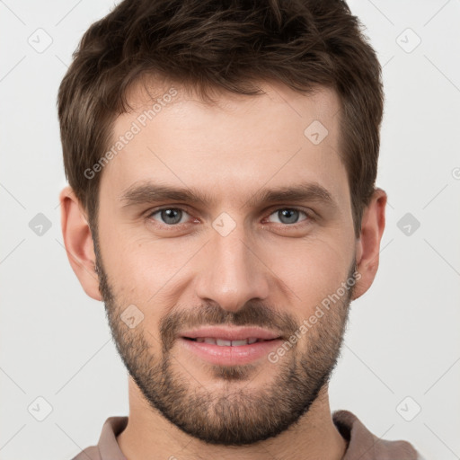 Joyful white young-adult male with short  brown hair and grey eyes