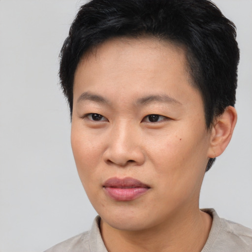 Joyful asian young-adult female with short  black hair and brown eyes