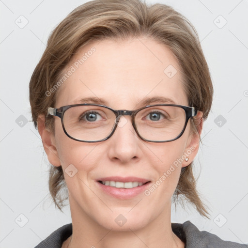 Joyful white adult female with medium  brown hair and blue eyes