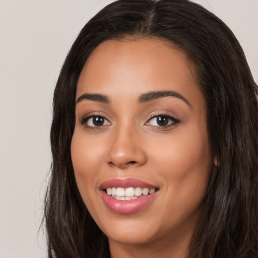 Joyful white young-adult female with long  black hair and brown eyes