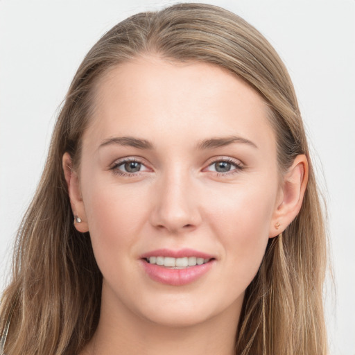 Joyful white young-adult female with long  brown hair and grey eyes