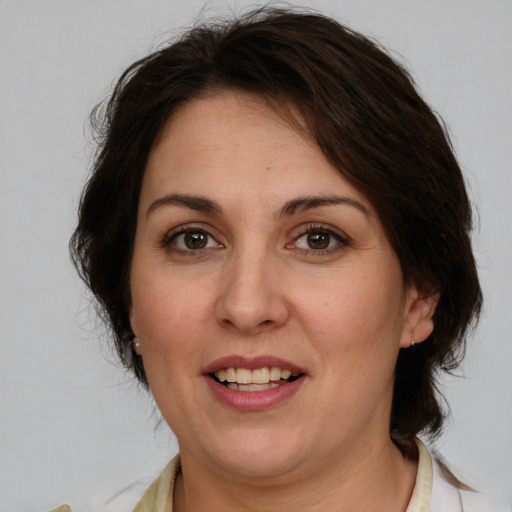 Joyful white adult female with medium  brown hair and brown eyes