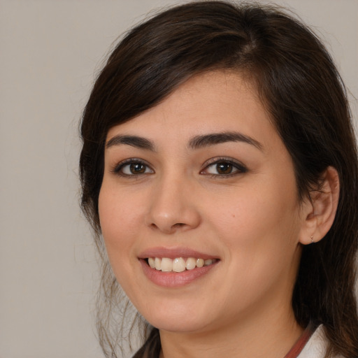 Joyful white young-adult female with medium  brown hair and brown eyes