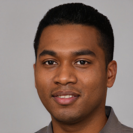 Joyful black young-adult male with short  black hair and brown eyes