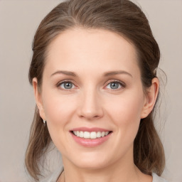 Joyful white young-adult female with medium  brown hair and grey eyes