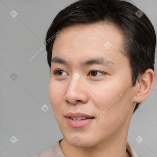 Joyful asian young-adult male with short  brown hair and brown eyes