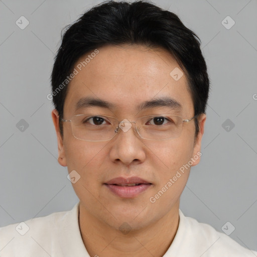 Joyful asian adult male with short  brown hair and brown eyes