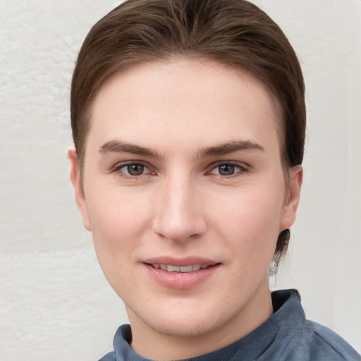 Joyful white young-adult female with short  brown hair and grey eyes