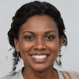 Joyful black young-adult female with medium  brown hair and brown eyes