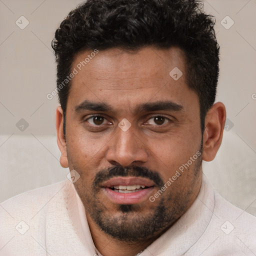 Joyful white young-adult male with short  black hair and brown eyes