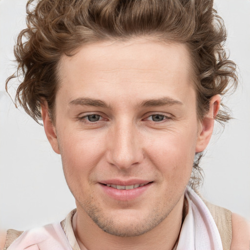 Joyful white young-adult male with short  brown hair and blue eyes