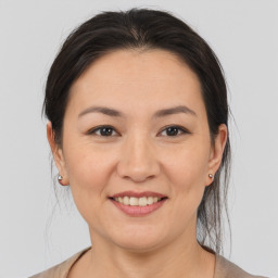 Joyful asian young-adult female with medium  brown hair and brown eyes