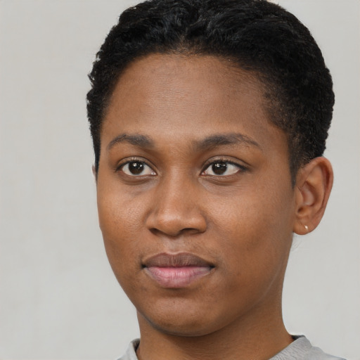 Joyful black young-adult female with short  black hair and brown eyes