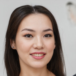 Joyful asian young-adult female with long  brown hair and brown eyes