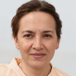 Joyful white adult female with short  brown hair and brown eyes