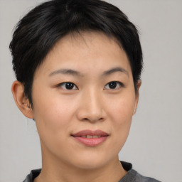 Joyful asian young-adult female with short  brown hair and brown eyes