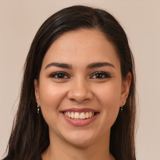 Joyful white young-adult female with long  brown hair and brown eyes