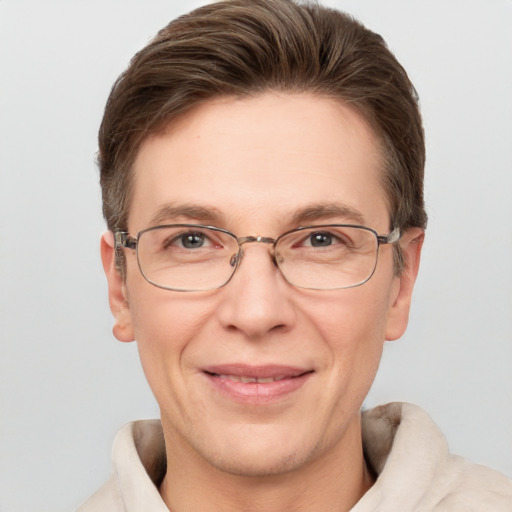 Joyful white adult male with short  brown hair and grey eyes