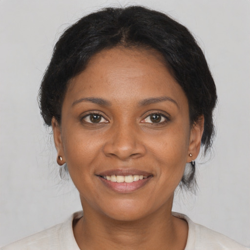 Joyful black young-adult female with short  brown hair and brown eyes