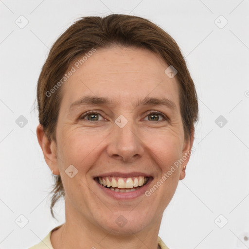 Joyful white adult female with short  brown hair and grey eyes